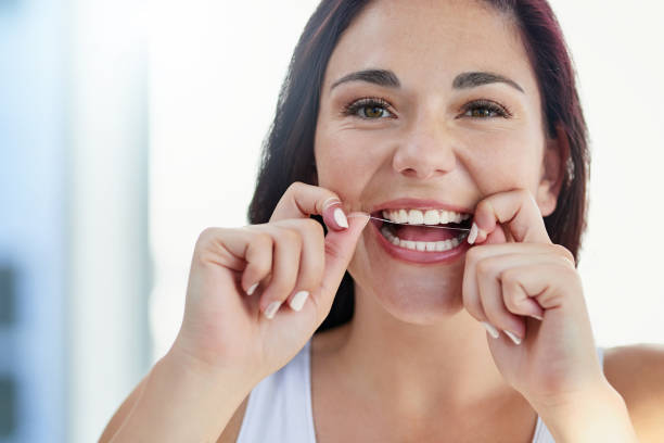  woman smiling while flossing