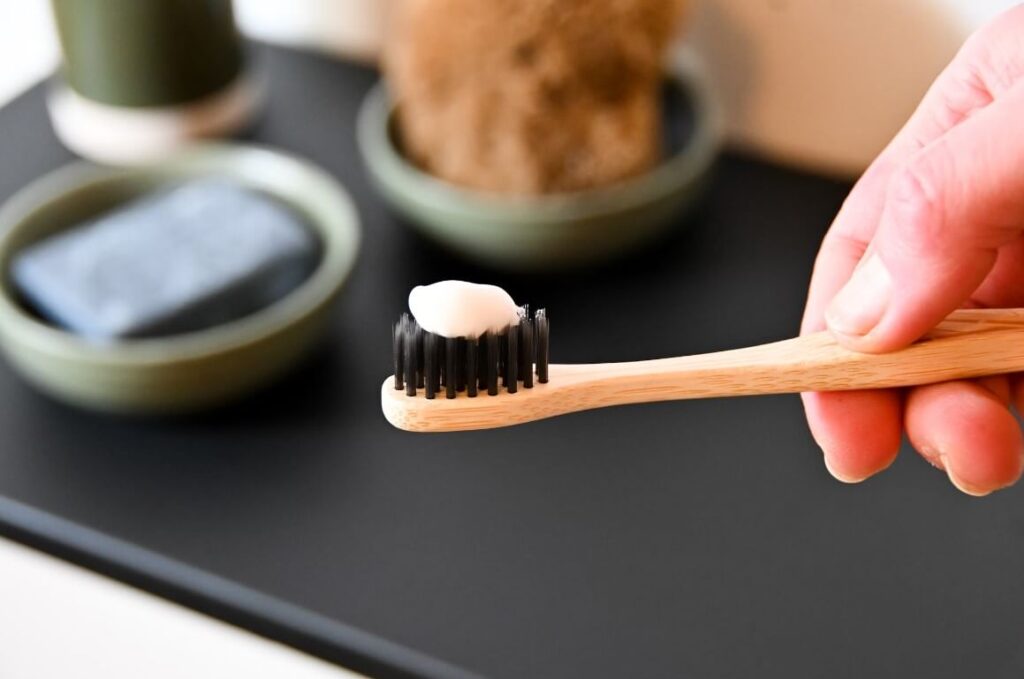 a toothbrush with a pea-sized amount of toothpaste