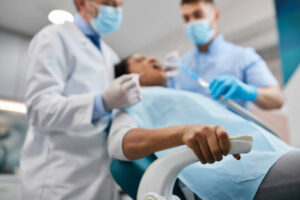 close-up of woman holding tight to a chair during dental procedure