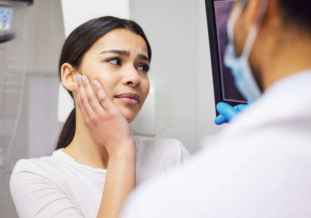 shot of a dentist discussing the results of a patient’s teeth x ray