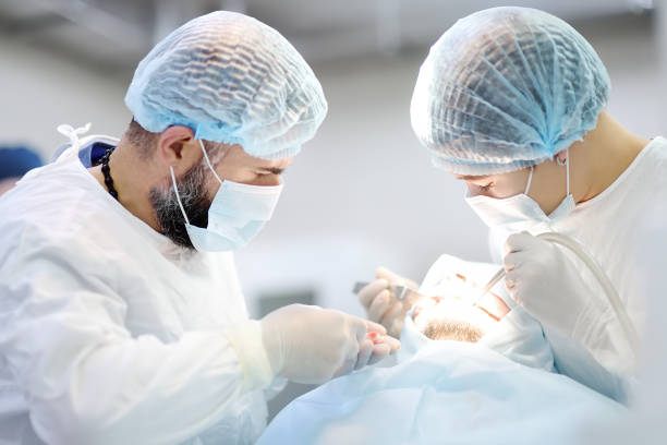 dentists working in a patient under the bright light